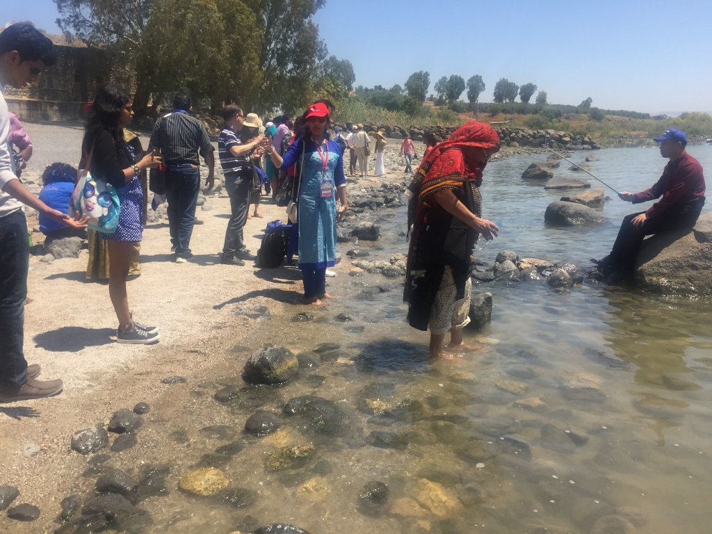 Pilgrims from every nation wade into the famous lake where Jesus taught and lived